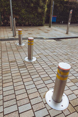 A set of of automatic rising hydraulic bollards on a pedestrianised street