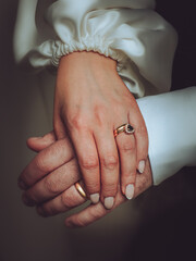 A pair of Newlyweds holding hands on their wedding day