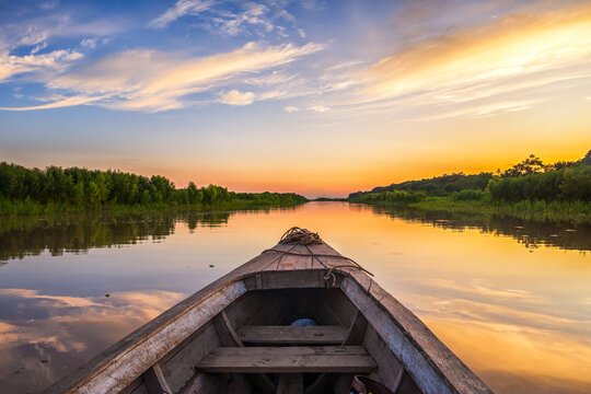 Wooden boat on Amazon River at sunset