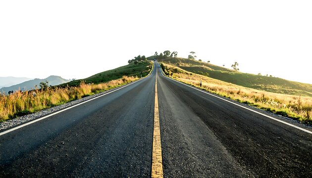 Asphalt road stretching toward a distant grassy hill against a bright, almost white sky. Sunny
