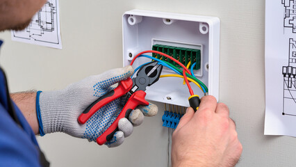 electrician fixing electrical outlet