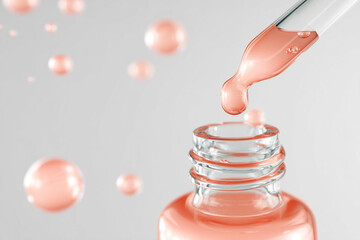 Serum dripping from pipette into glass bottle with peach liquid