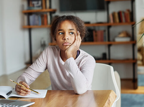 Mother and daughter doing homework with laptop fighting and arguing over learning at home. Motherand teenage daughter girl using laptop. Girl and mom mum sitting at home working with notebook, girl  b