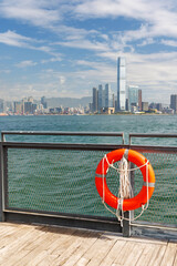 Fototapeta premium Hong Kong skyscraper panorama on a sunny day with water and boats