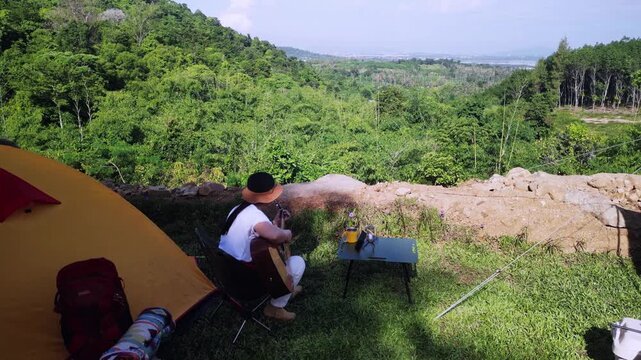 Asian women camping alone with mountain view. Solo outdoor activity and journey lifestyle on holiday.