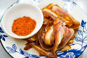 Spicy Sichuan Pork Ear with Chili Dip on Ceramic Plate