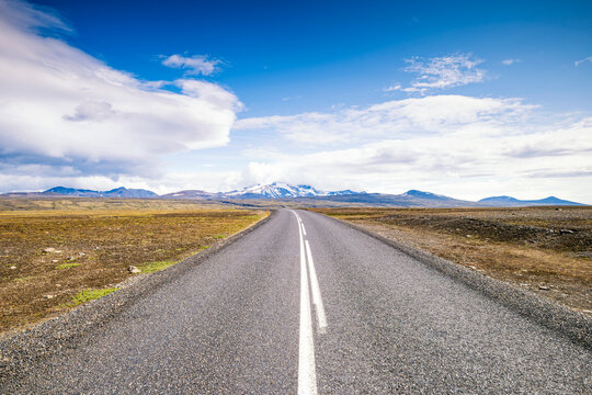 Deserted highway 910 in M��rudals�r�fi with snow-covered mountains