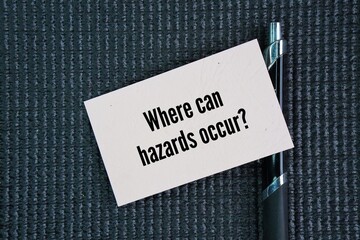 Pen and paper with the wording of questions about safety ie Where can hazards occur? impacting people, property, and ecosystems through physical, biological, chemical, ergonomic, or psychosocial risks