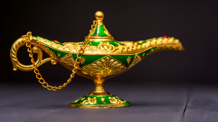 Magic golden lamp gin lamp. Fabulous gin lamp on a black background. High quality photo