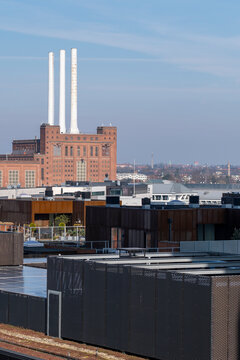 Overcast urban skyline with brick factory building features smokestack and chimney showing industry power character and city architecture in grey