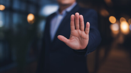 Businessman's open hand showing a stop gesture, preventing access, setting limitations, signifying refusal, denial, protection, warning, and boundary concept, copy space