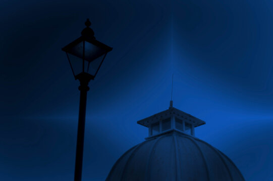 Lamp post and pier roof against a stylised blue background