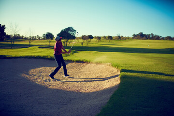Fototapeta premium Golf club, training or person in sand pit with swing, fitness hobby or performance on weekend break. Sport, man or golfer in bunker with shot, outdoor activity or practice session on Sunday afternoon