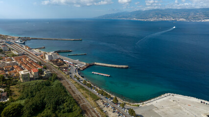 Fototapeta premium Aerial view of the Villa San Giovanni waterfront, located in the province of Reggio Calabria, Italy. It is a port city overlooking the Strait of Messina. Across the sea is the coast of Sicily.