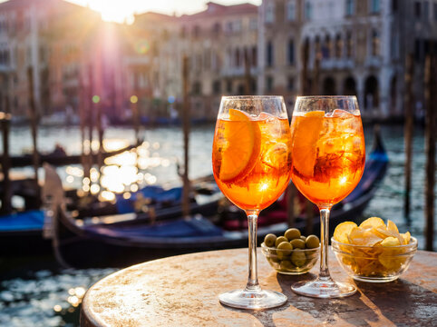 Italian aperitivo with orange spritz cocktail and snacks on terrace sunset lifestyle drink celebration summer evening background copy space venice italy