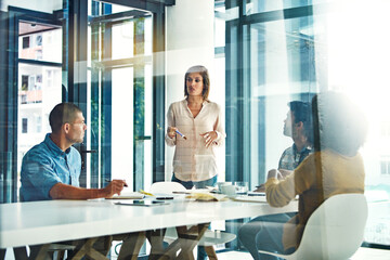 Obraz premium Boardroom, meeting and training with designer people in workplace together for coaching or update. Collaboration, explain and upskill presentation with employee group in glass office for development