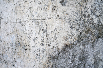 Cracked rough concrete wall with weathered surface