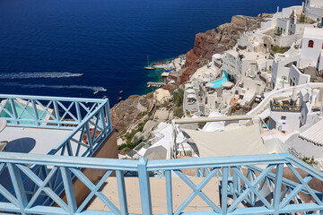 Naklejka premium Whitewashed houses with terraces and pools and a beautiful view in Oia on Santorini island, Greece