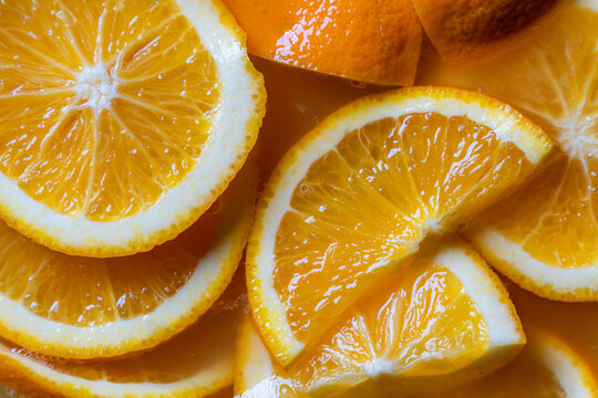 pile of fresh orange slices close up as vibrant citrus food background