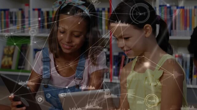 Girls reaching for tablets in library powering screens and learning with data overlay intensifying