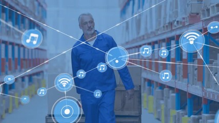 Animation of network of connections with icons over caucasian male worker in warehouse - Powered by Adobe