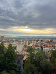 Fototapeta premium cityscape of Granada under a clear sky, highlighting its unique blend of Moorish and Spanish architecture that attracts visitors from around the world. Travel features, cultural documentaries