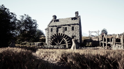 Fototapeta premium A charming stone mill stands proudly near swaying fields of golden wheat. Bright sunlight illuminates the scene, creating a peaceful rural atmosphere.