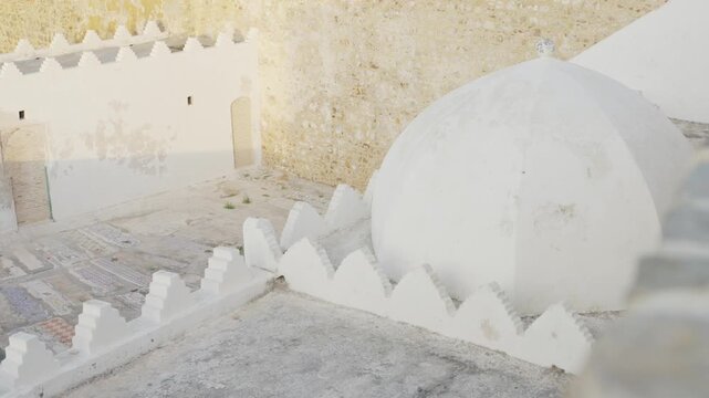 Assilah, Morocco - May 8, 2024: Shot on camera. An orbit close-up shot of a historic landmark in the old Medina of Assilah, Morocco, featuring the sacred Mausoleum of Sidi Ahmed Ben Mansour, highlight