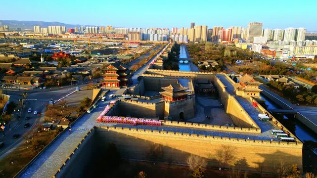 Aerial view of the Datong Ancient City with its formidable walls and traditional architecture contrasting with modern buildings in the distance, Datong, Shanxi, China.