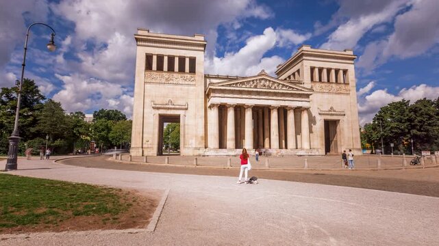 Hyperlapse timelapse footage of Munich featuring the Propylaea monument at K&ouml;nigsplatz, Germany. The historic landmark stands at the heart of the Munich cityscape while dynamic camera movement creates