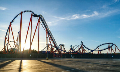 Obraz premium SUN FLARE: Gorgeous sunset illuminates an empty roller coaster ride in LA.