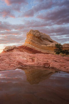 View of a serene reflection of a sandstone formation kissed by the warm hues of the setting sun, creating a mirage-like effect, Marble Canyon, Arizona, United States.