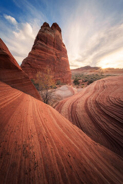 View of swirling red sandstone formations rise under a sky streaked with dawn's first light, a timeless dance of earth and sky, Marble Canyon, Arizona, United States.