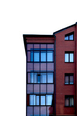 Obraz premium Modern brick building facade with large glass windows isolated on white. Minimal urban architecture