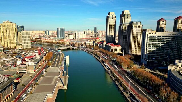 Aerial view of the Haihe River winding through the city, framed by modern buildings and roads, showcasing urban development, Tianjin, Tianjin, China.