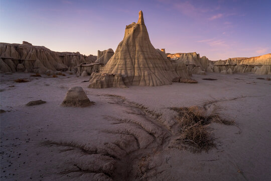 View of eroded badlands formations under a serene twilight sky, showcasing the stark beauty of the desert landscape, Albuquerque, New Mexico, United States.