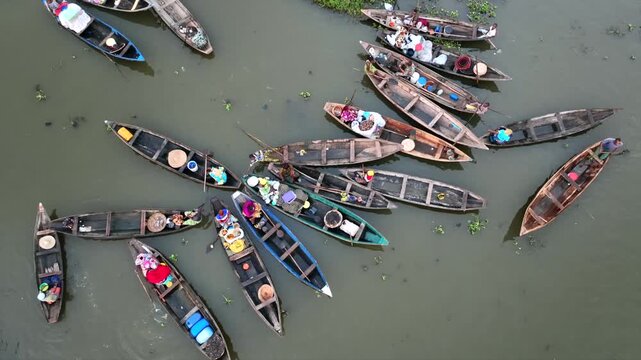Aerial view of boats filled with people and goods traversing the waterways, showing a vibrant scene of commerce, Ganvie, Atlantique Department, Benin.