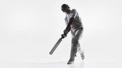 Obraz premium Cricket player front foot batting technique in studio isolated on white. Concept of cricket skill development, timing training, instructional batting content and professional sport education materials