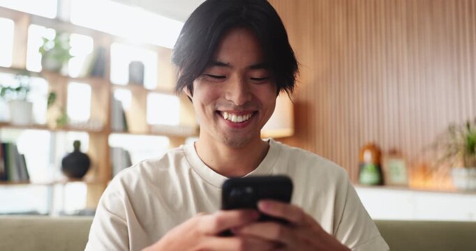 Asian man, student and smile with phone in house for education results, university application or acceptance. Person, tech and good news of study registration, scholarship feedback and notification