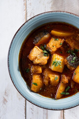 Cod with potatoes on white wooden table.Traditional Spanish dish