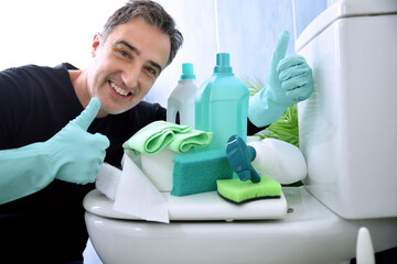 Man making ok and various cleaning products in blue toilet