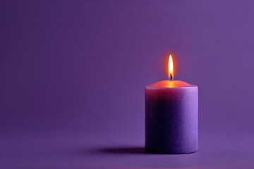 Purple candle against a violet backdrop shining orange glow