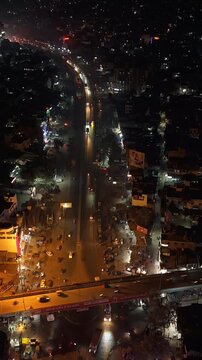 Aerial Night Timelapse of Busy Indian City Street with Flyover and Urban Traffic Flow.