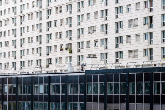 Urban grid of modernist apartment facade with windows in La Defense Paris showing residential architecture for documentary editorial
