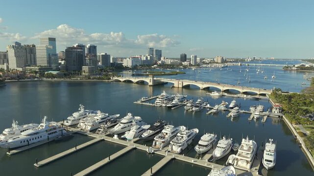 Aerial view of bridge contrasting against the still water, boats, and buildings, West Palm Beach, Florida, United States.