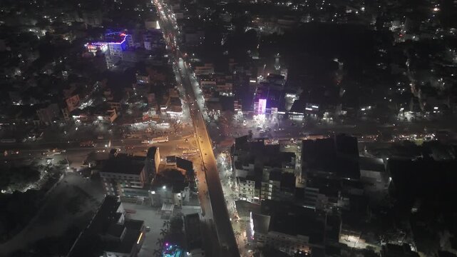 Aerial Night Timelapse of Busy Indian City Street with Flyover and Urban Traffic Flow.