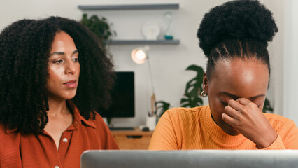 Two Women in a Modern Office Scene Showing Focus and Support in a Startup Team