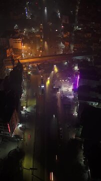 Aerial Night Timelapse of Busy Indian City Street with Flyover and Urban Traffic Flow.