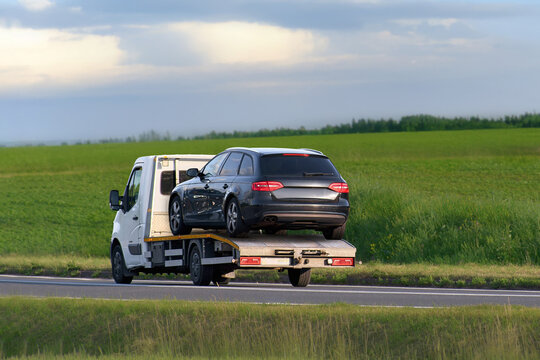 Car being towed by roadside assistance vehicle