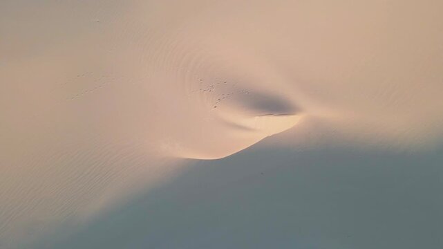 Aerial view of the textured sandy dunes, the wind creating patterns in the sand, showing a contrast in light and shadow, Betty's Bay, Western Cape, South Africa.